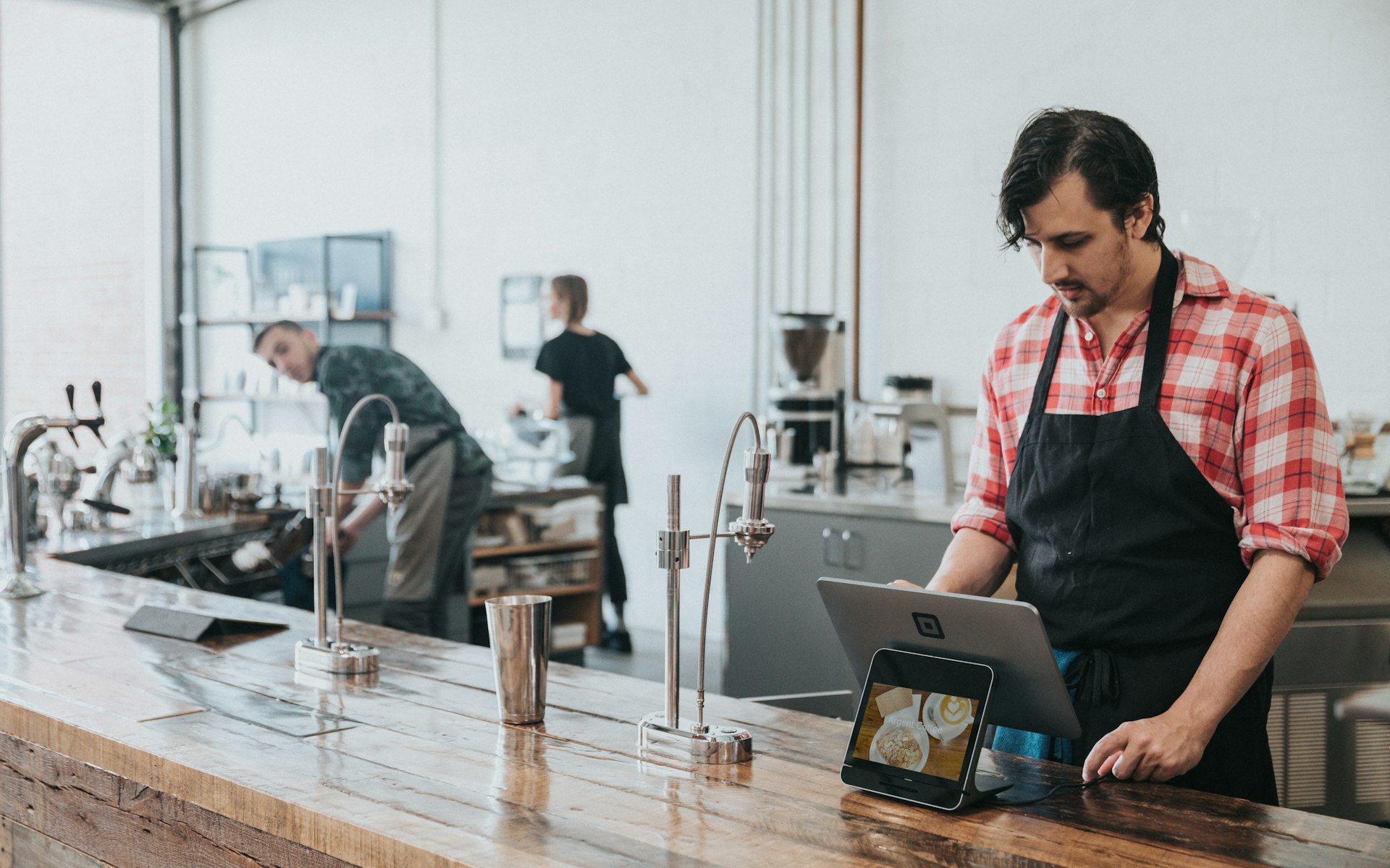 Payroll Funding When You Need Money for Wages This Week – Cafe owner at the counter